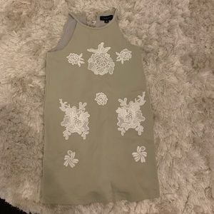 Green dress with white lace flowers.